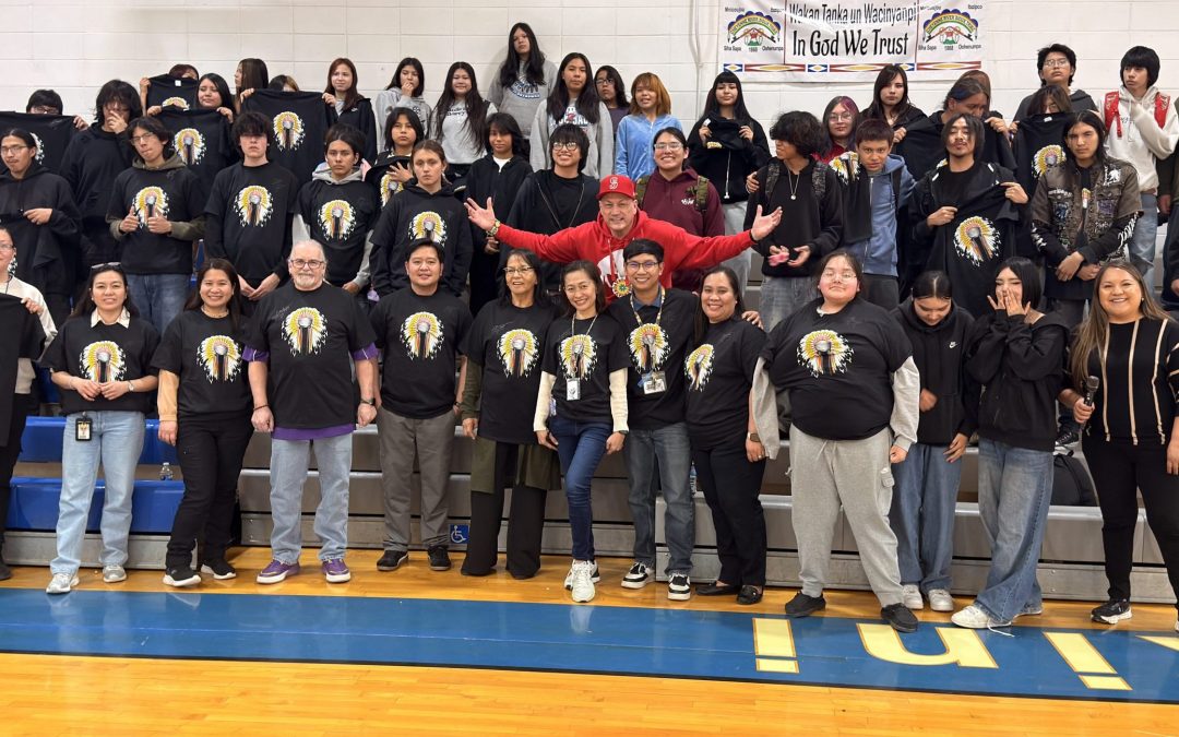 Group of students and staff posing together with Litefoot